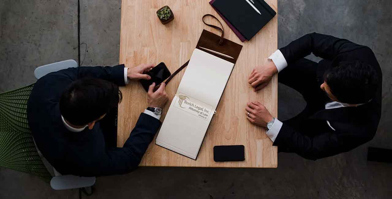 Peter T. Borich reviewing a case with a client, Borich Legal Inc
